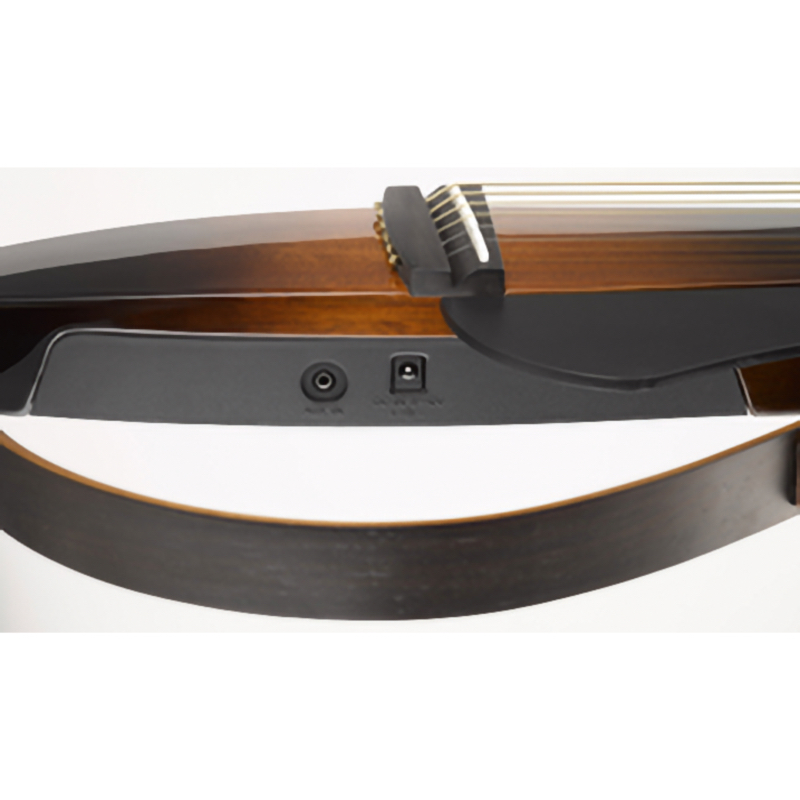 Close-up of a guitar body with a strap attached and an output jack on the side of a wooden finish.